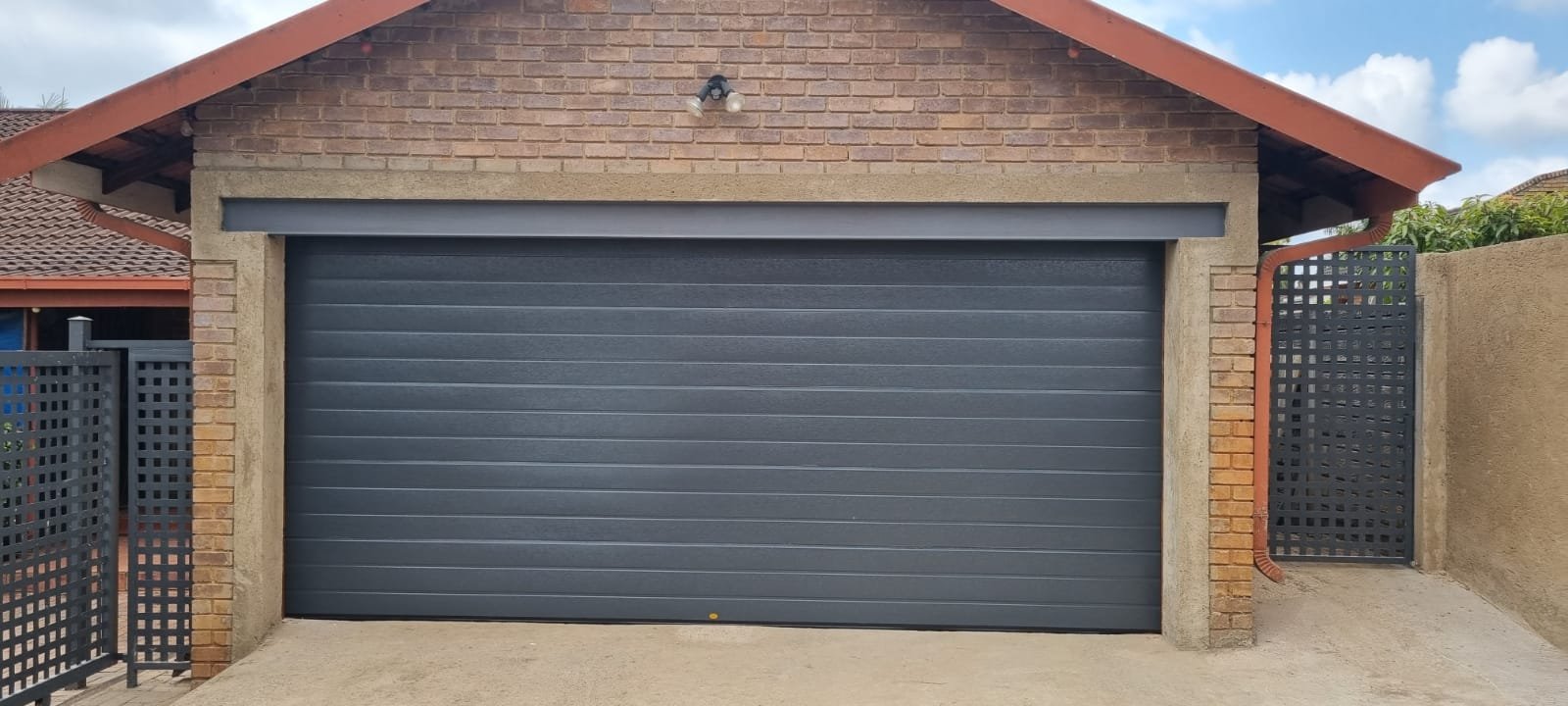 Garage door upgrade — wall-to-wall sectional door fitted by MZSteel