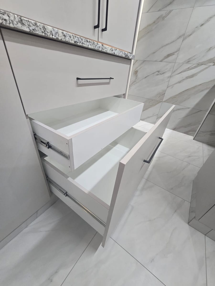 Deep kitchen drawers open, showing clean white drawer boxes