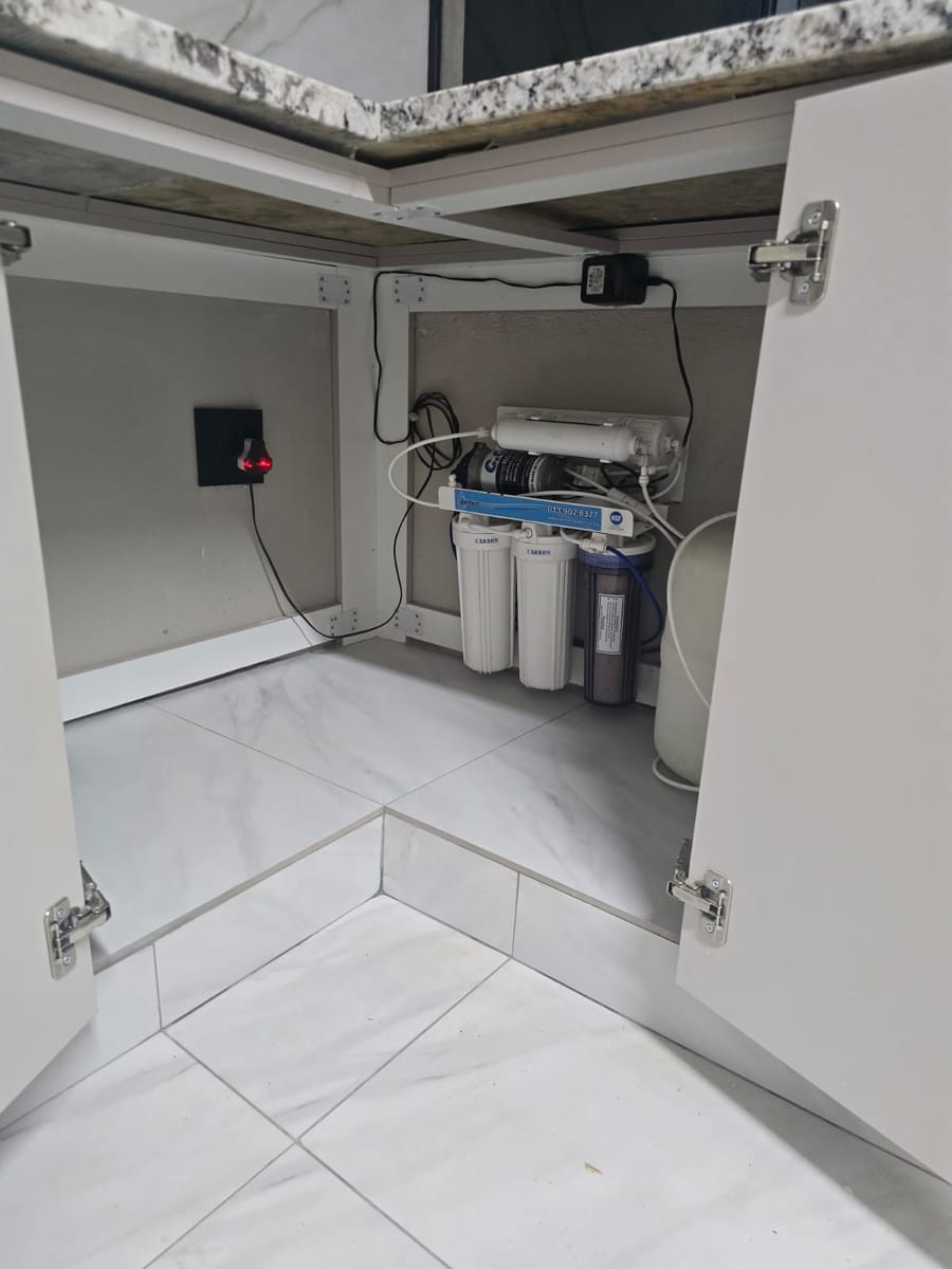 Under-sink water purification system installed by MZ Steel & Construction in the new sink cupboard