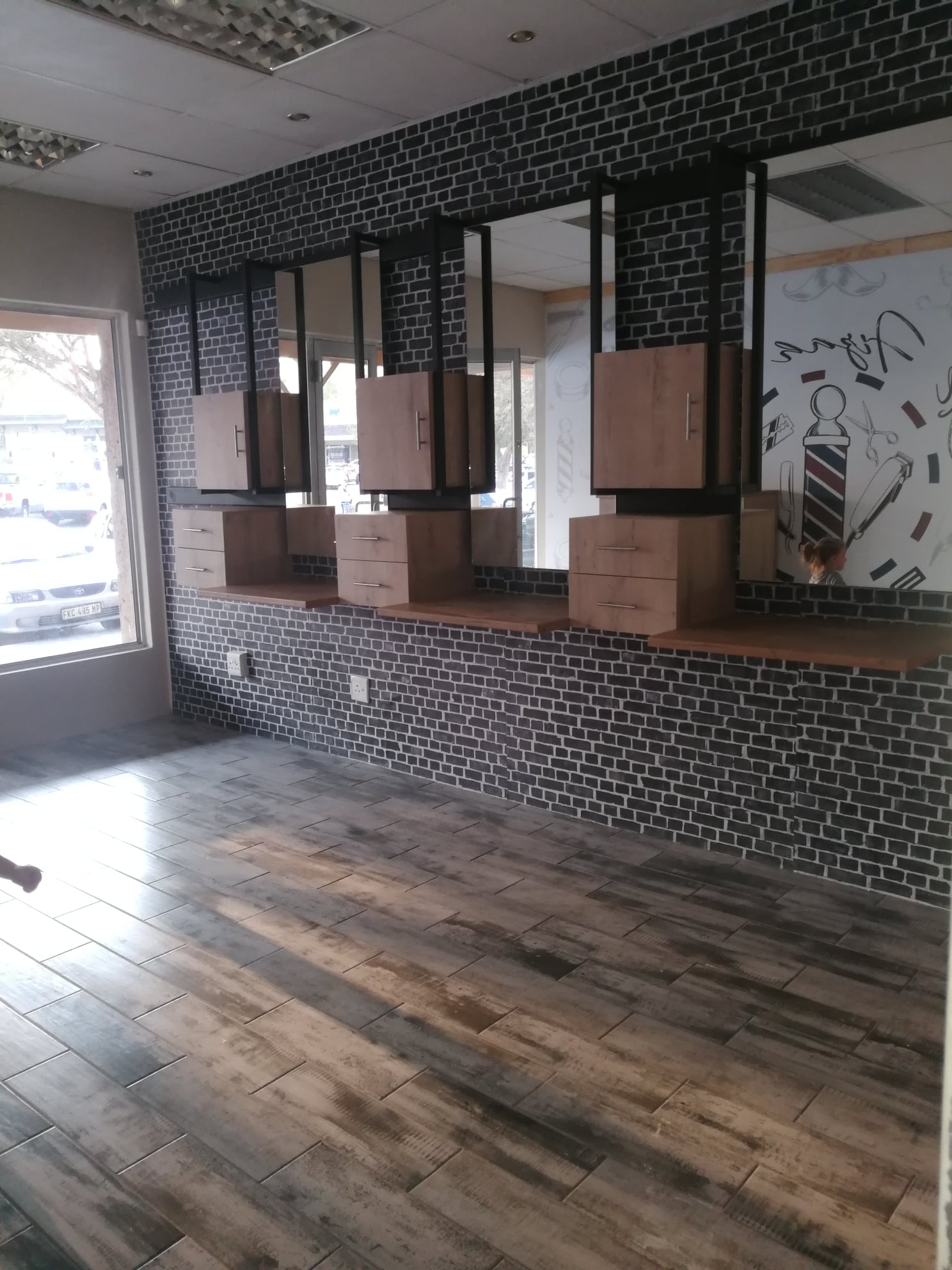 Wood-look floor tiles and feature wall tiling in a shop fit-out by MZ Steel & Construction